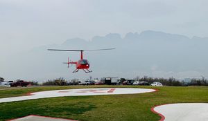 Preview wallpaper helicopter, runway, pad, fog, red