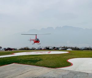 Preview wallpaper helicopter, runway, pad, fog, red