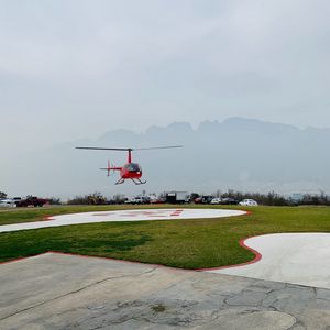 Preview wallpaper helicopter, runway, pad, fog, red