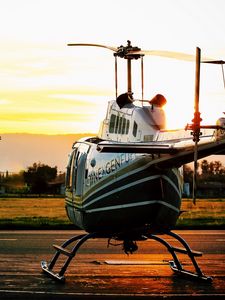 Preview wallpaper helicopter, sunset, airfield