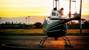 Preview wallpaper helicopter, sunset, airfield