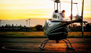 Preview wallpaper helicopter, sunset, airfield