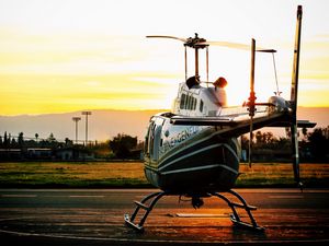 Preview wallpaper helicopter, sunset, airfield