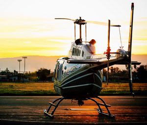 Preview wallpaper helicopter, sunset, airfield