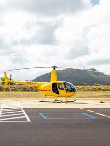 Preview wallpaper helicopter, yellow, asphalt, hill