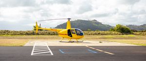 Preview wallpaper helicopter, yellow, asphalt, hill