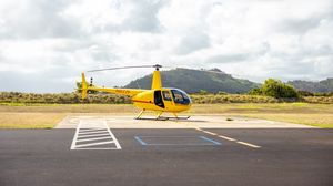 Preview wallpaper helicopter, yellow, asphalt, hill