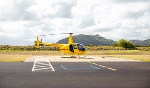 Preview wallpaper helicopter, yellow, asphalt, hill