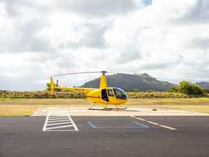 Preview wallpaper helicopter, yellow, asphalt, hill