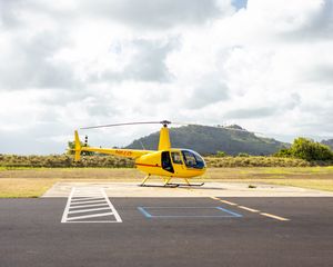 Preview wallpaper helicopter, yellow, asphalt, hill