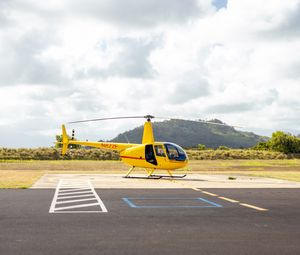 Preview wallpaper helicopter, yellow, asphalt, hill