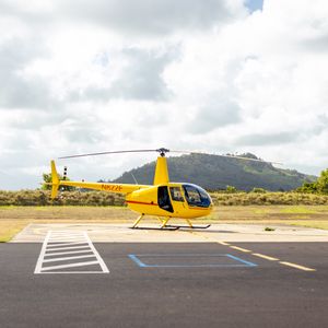 Preview wallpaper helicopter, yellow, asphalt, hill
