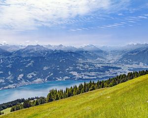 Preview wallpaper hill, grass, mountains, sea, clouds, nature