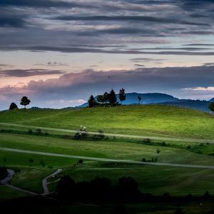 Preview wallpaper hill, grass, trees, road, sky