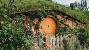 Preview wallpaper hill, house, cave, door, flowers