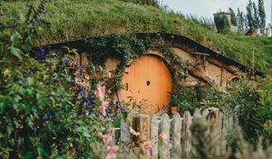 Preview wallpaper hill, house, cave, door, flowers