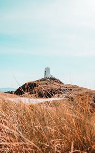 Preview wallpaper hill, lighthouse, grass, coast, nature