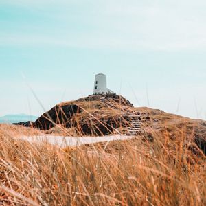 Preview wallpaper hill, lighthouse, grass, coast, nature