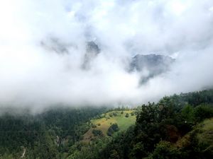 Preview wallpaper hill, mountains, trees, fog, clouds, landscape