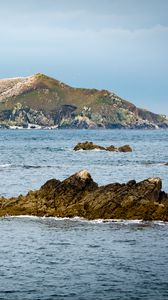 Preview wallpaper hill, rocks, stones, sea, nature