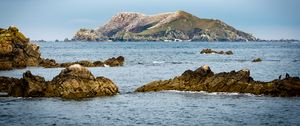 Preview wallpaper hill, rocks, stones, sea, nature