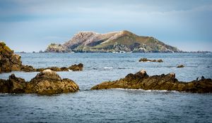 Preview wallpaper hill, rocks, stones, sea, nature