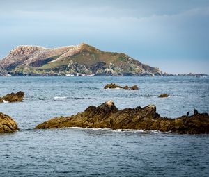 Preview wallpaper hill, rocks, stones, sea, nature