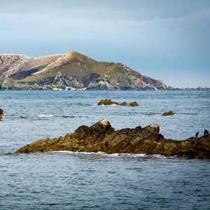 Preview wallpaper hill, rocks, stones, sea, nature