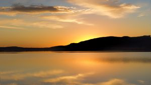 Preview wallpaper hill, silhouette, sunset, water, reflection