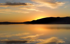 Preview wallpaper hill, silhouette, sunset, water, reflection