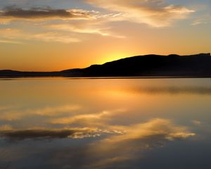 Preview wallpaper hill, silhouette, sunset, water, reflection