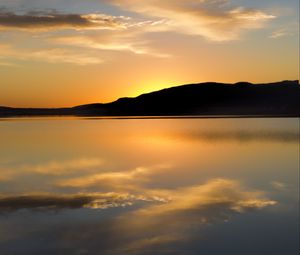 Preview wallpaper hill, silhouette, sunset, water, reflection