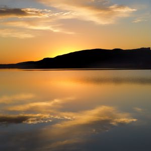 Preview wallpaper hill, silhouette, sunset, water, reflection