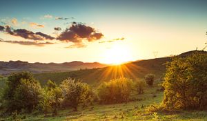 Preview wallpaper hill, slope, rays, grass, sun