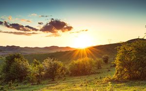 Preview wallpaper hill, slope, rays, grass, sun