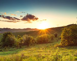 Preview wallpaper hill, slope, rays, grass, sun