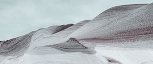 Preview wallpaper hill, snowdrift, loose, wavy, hilly, gray