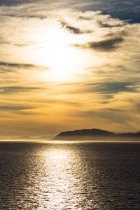 Preview wallpaper hill, sunset, clouds, sea, glare