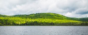 Preview wallpaper hill, trees, forest, river, sky, clouds