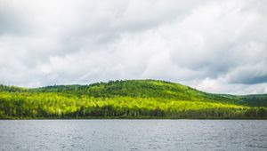 Preview wallpaper hill, trees, forest, river, sky, clouds