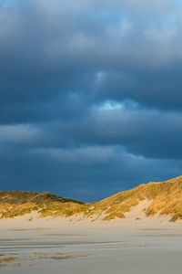 Preview wallpaper hills, beach, clouds, sky, dark, landscape