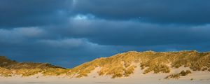 Preview wallpaper hills, beach, clouds, sky, dark, landscape