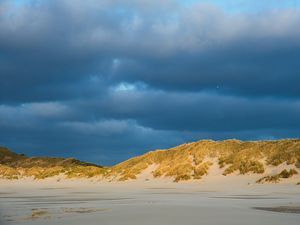 Preview wallpaper hills, beach, clouds, sky, dark, landscape