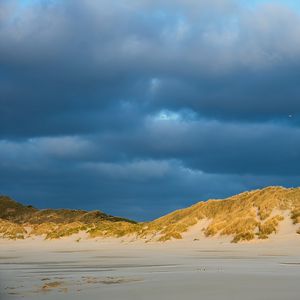 Preview wallpaper hills, beach, clouds, sky, dark, landscape