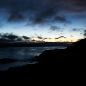 Preview wallpaper hills, coast, sea, silhouettes, evening