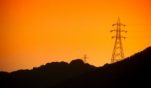 Preview wallpaper hills, electric poles, dusk, sunset, orange