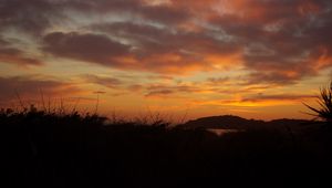 Preview wallpaper hills, grass, silhouettes, evening, sunset