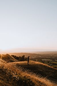 Preview wallpaper hills, man, silhouette, sunset, landscape