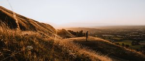 Preview wallpaper hills, man, silhouette, sunset, landscape