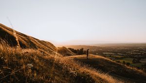 Preview wallpaper hills, man, silhouette, sunset, landscape